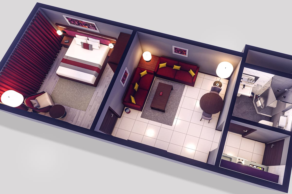A hotel room layout with a bed, seating area, and a bathroom.