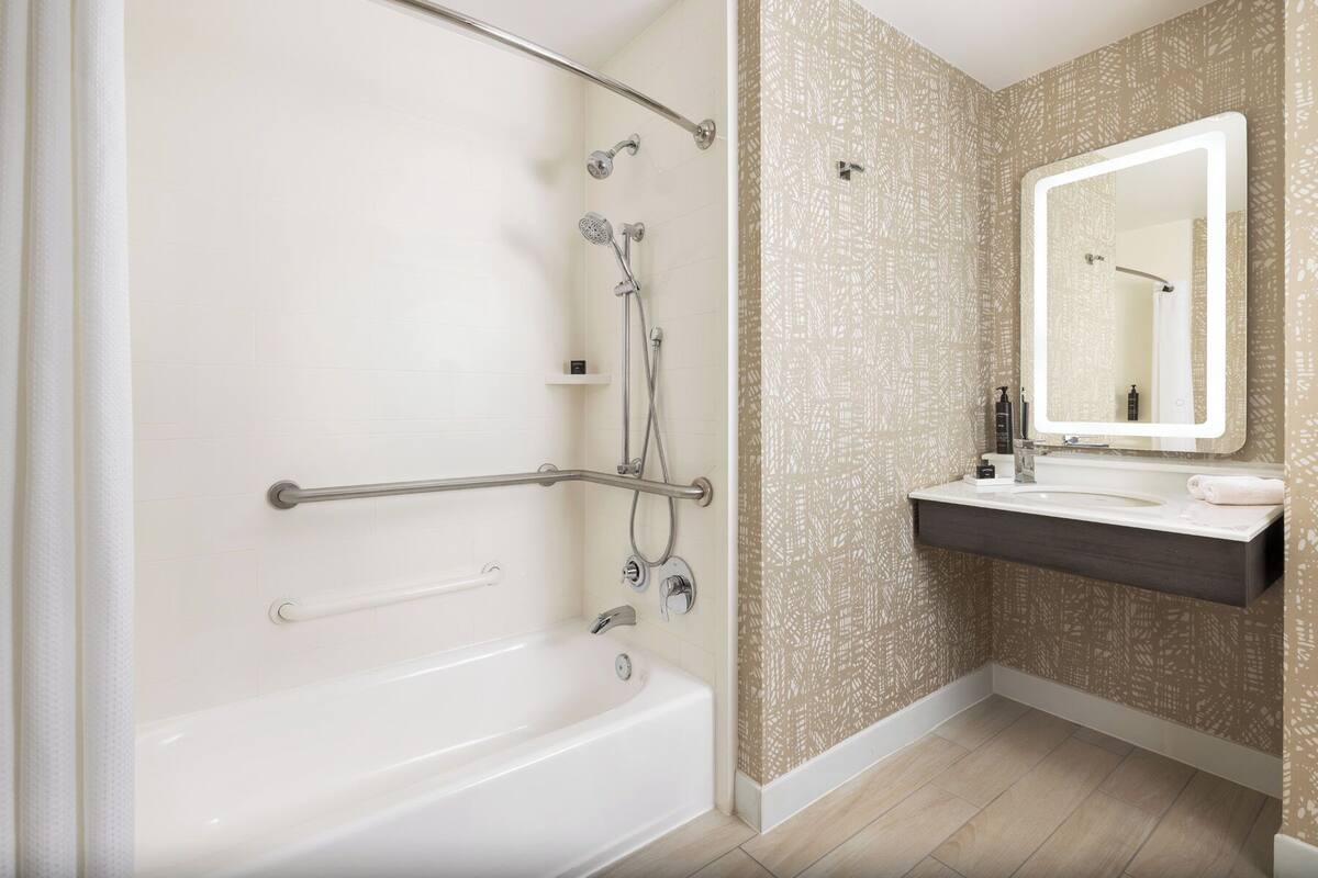 designer toiletries, hair dryer, slippers, towels