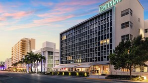 A modern hotel with a prominent "Continental" sign, featuring a grid of windows and a flat facade. - Hotel Continental Miami Beach, Tapestry Collection by Hilton (Miami Beach)