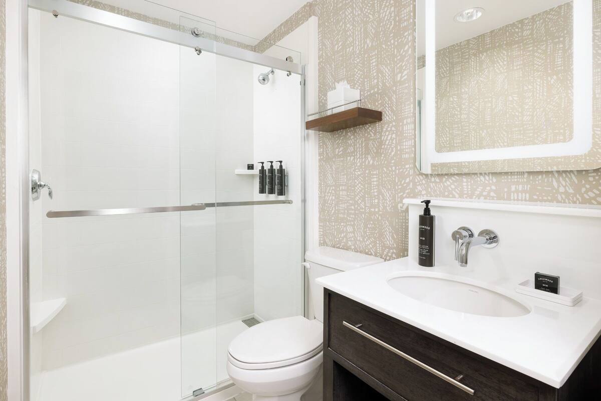 designer toiletries, hair dryer, slippers, towels