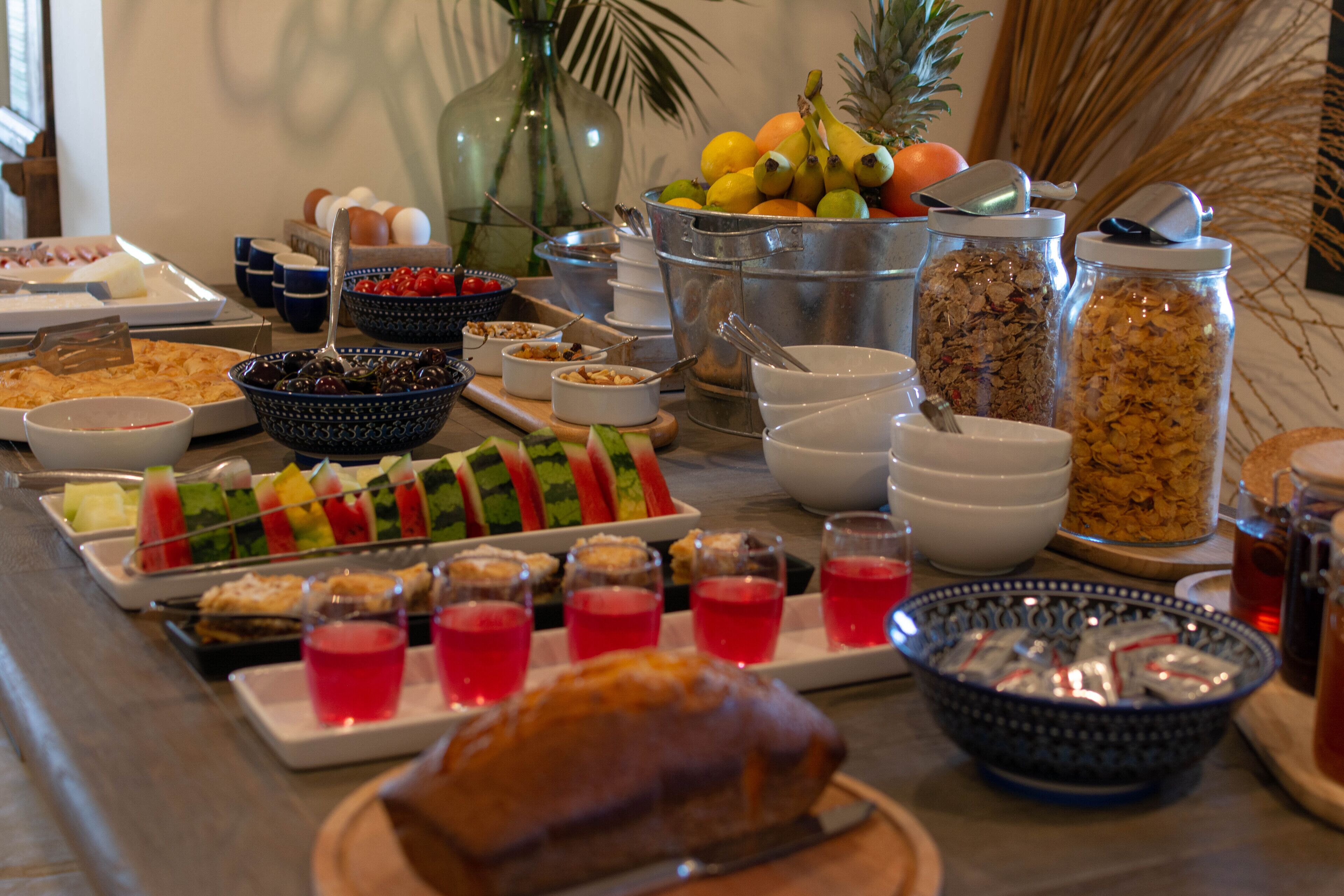 A buffet with various food items and beverages.