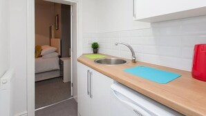 A compact kitchenette with a sink, a countertop, and a small cabinet. - Townhouse @166 Ruskin Rd (Crewe)