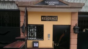 A residential building with a sign reading "THE ADDRESS DENVER" and "RESIDENCE". - The Address Denver Residence (Douala)