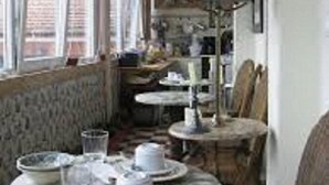 A narrow room with a high ceiling, a window with curtains, and a table set with plates and cups. - Shepinetree - Pinheira House (Sintra)