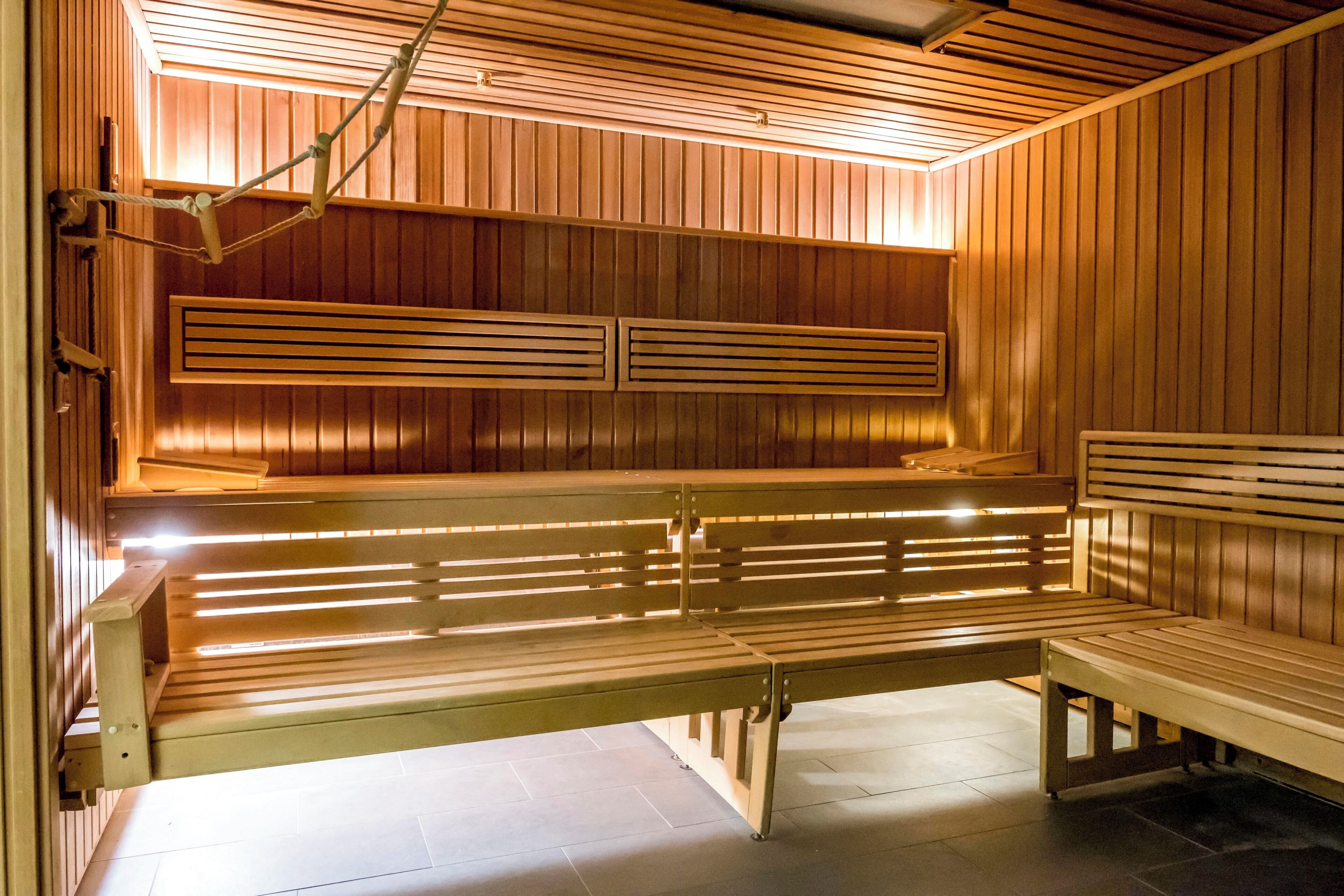A sauna with wooden benches and slatted walls.