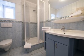 A bathroom with a shower, toilet, and sink. - Kleines Hotel Wemhoff (Winterberg)