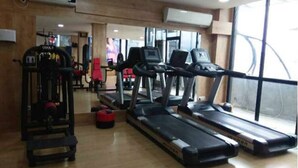 A gym with treadmills, a weight machine, and a mirror. - Zeleny Dom (Kobuleti)