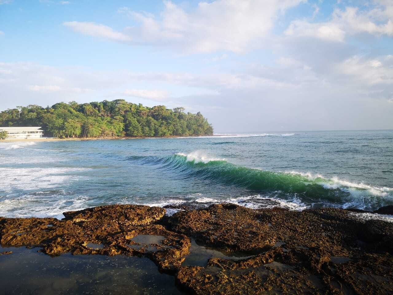 A rocky shoreline with waves crashing onto the rocks.