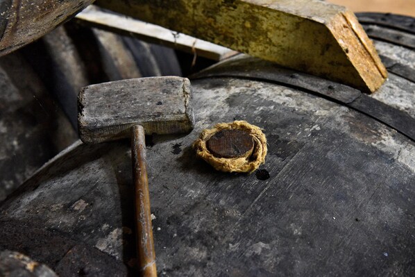A hammer and a circular object on a worn surface. - Domaine d'Arcalis (Archiac)