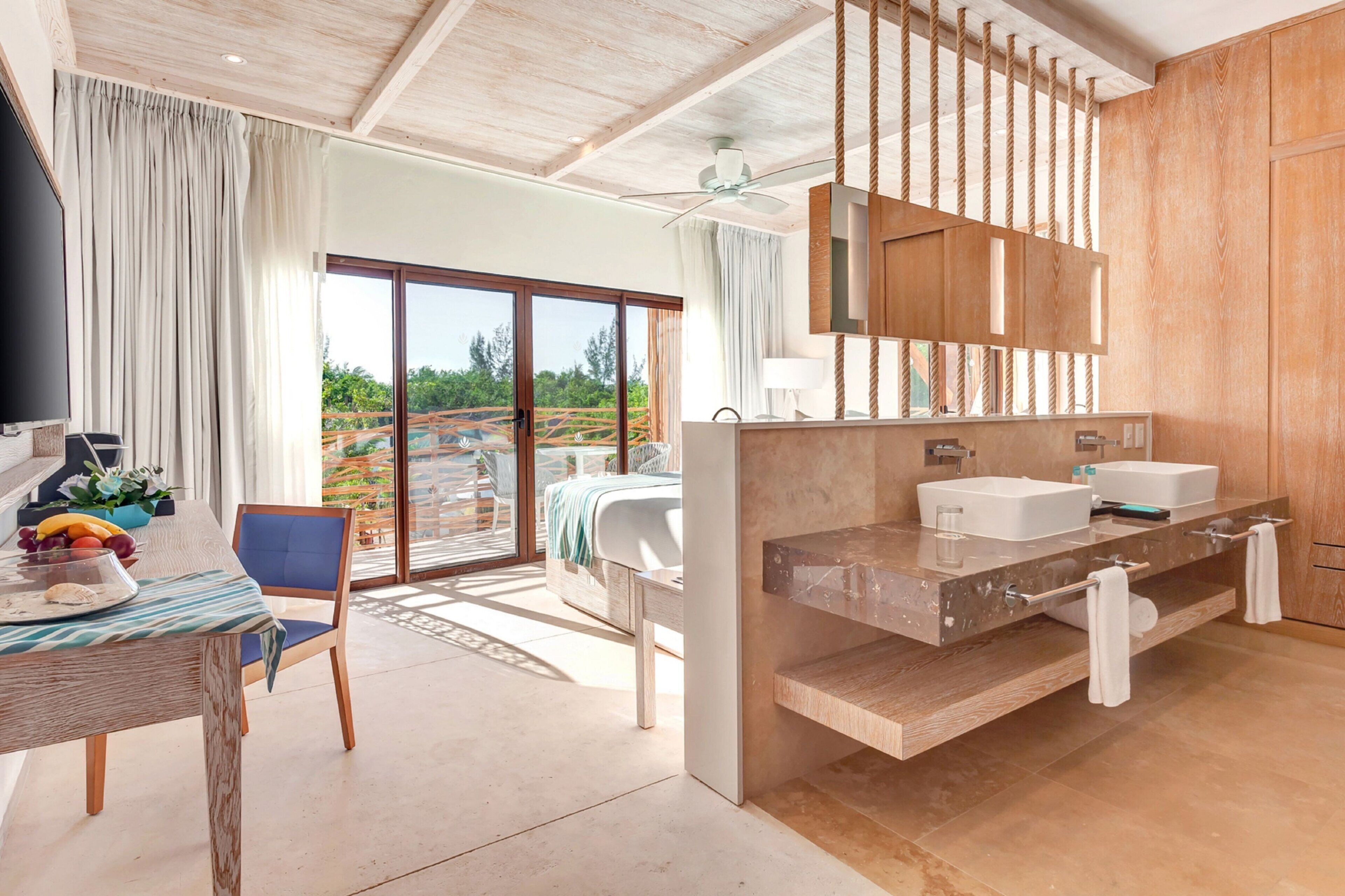 A modern bathroom with a wooden vanity, two sinks, and a large mirror.