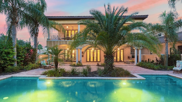A pool with a house in the background.