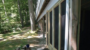 A pathway leading to a building with large windows and a wooden exterior. - Quiet Riverfront getaway to enjoy Midcoast Maine! (Damariscotta)