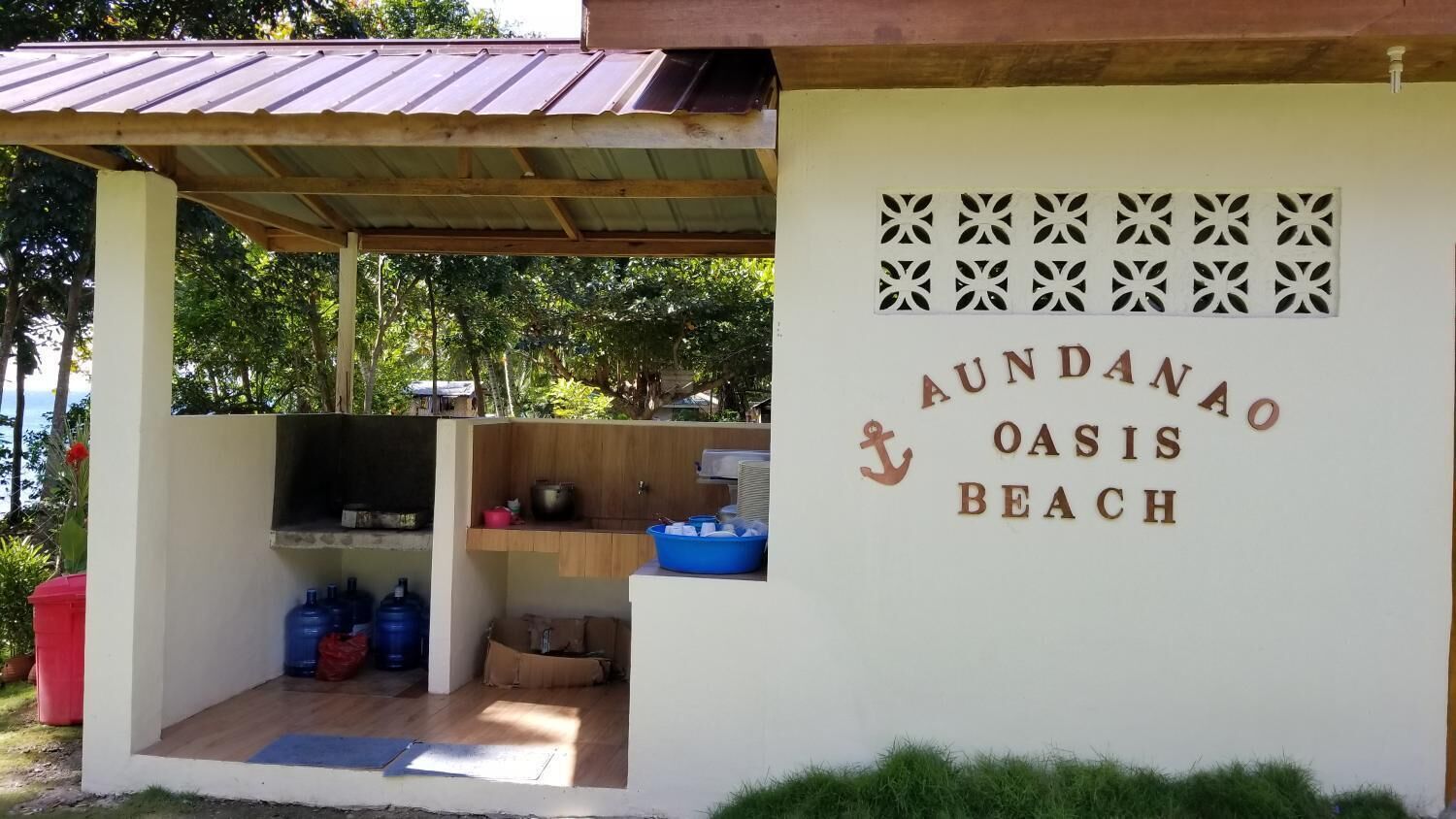 A beachside structure with a sign reading "Aundanao Oasis Beach".