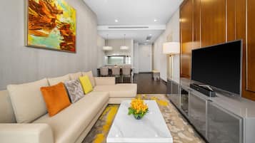 A modern living room with a sofa, coffee table, and a flat-screen TV.