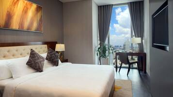 A hotel room with a large bed, a desk, and a view of the city.