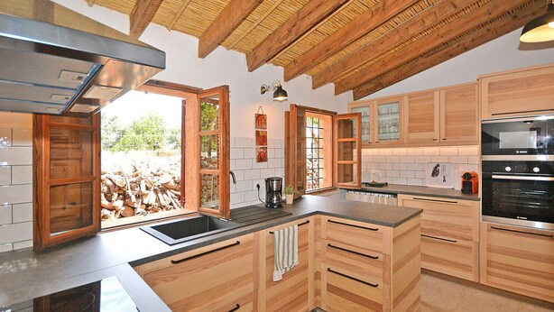 A kitchen with wooden cabinets, a stainless steel sink, and a Bosch oven. - Can Cortana - Charming country house with pool in Inca, Mallorca (Inca)