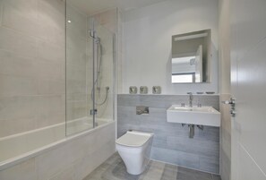 A modern bathroom with a glass-enclosed shower, a white toilet, and a sink with a mirror above it. - 3 Bed in Woolacombe (oc-5byron) (Woolacombe)