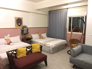 A bedroom with two beds, a bench, a chair, a hanging chair, and a window with curtains. - Beauty Home Homestay (Hualien City)