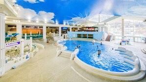 An indoor swimming pool with a high ceiling and a mural of clouds. - Fujino Kirameki (Gotemba)