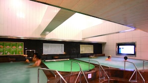 A traditional Japanese onsen with multiple hot spring pools, wooden railings, and informational signs. - Nikoh Capsule Hotel Refre - Hostel - Caters to Men (Sapporo)
