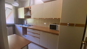 A compact kitchen with a microwave, a sink, and cabinets. - Selva 1 lake view apartment in Ghiffa with pool (Ghiffa)