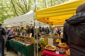 A market stall with various food items and a signboard.