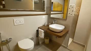 Bathtub, hair dryer, bidet, towels