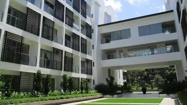 A modern multi-story building with balconies and a central courtyard. - PODZzz Suites at Aeropod - K2-07-10A (Kota Kinabalu)