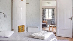 A bedroom with a bed, a nightstand, a wardrobe, and a bathroom visible through an open door. - Nice home in Växjö with kitchen (Växjö)