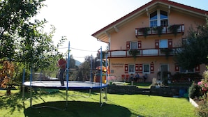 Un trampolino in un'area erbosa, con un edificio sullo sfondo.