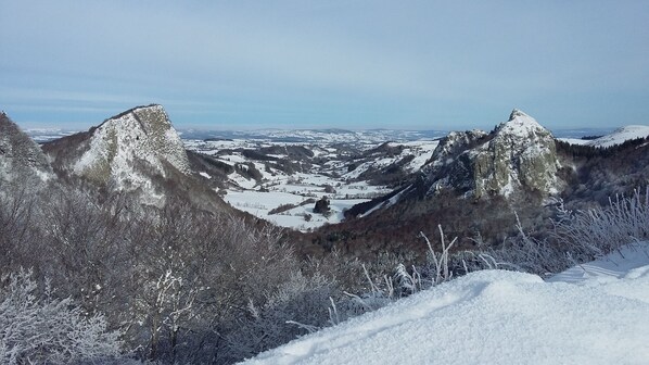 A mountainous landscape with snow-covered peaks and valleys.