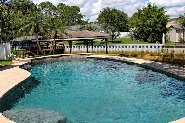 Resort style pool with canal view.