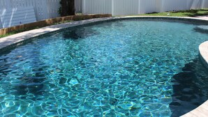 A clear swimming pool with a tiled edge and a wooden deck surrounding it. - Look Promo DEALS, Resort Like Waterfront, Orlando 4/2 Home, Private Pool, Dock (Orlando)