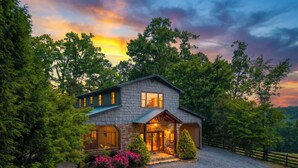 A two-story house with a stone facade, large windows, and a gravel driveway. - Moonlight Retreat - Blue Ridge, Ga. (Blue Ridge)