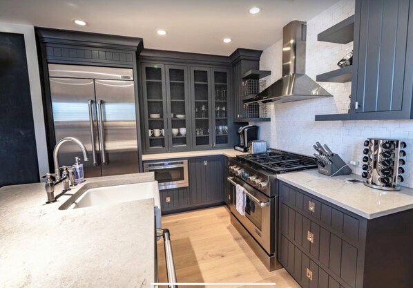 Enjoy cooking in this well-equipped kitchen with a stainless steel refrigerator, oven, and gas stove.