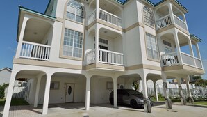 A multi-story building with balconies and a covered parking area. - The Palms Studio, whirlpool, pool (Panama City Beach)