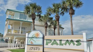 A sign for 'The Palms' with a number '17878' and palm trees in the background. - The Palms Studio, whirlpool, pool (Panama City Beach)