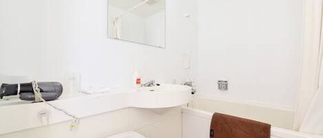 A bathroom with a white sink, mirror, and a towel rack.