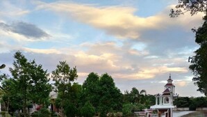 A serene garden with a pond, a gazebo, and lush greenery. - The Lighthouse Resort At Chanthaburi (Chanthaburi)