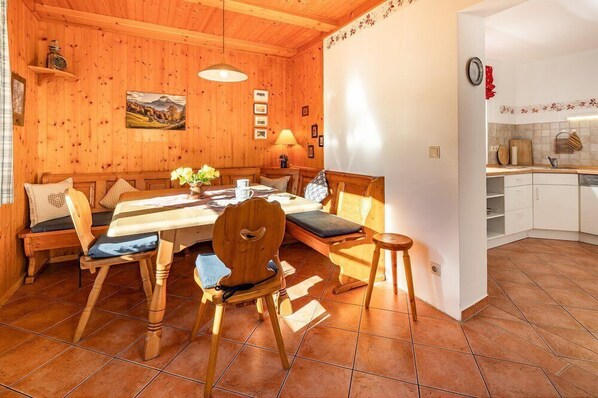 A cozy wooden dining area with a table, chairs, and a bench.