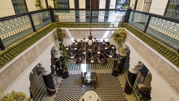 A spacious courtyard with a central fountain, ornate railing, and patterned floor tiles. - Riad Ben Tachfine (Marrakech)