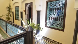 A staircase with ornate metal railings and a potted plant. - Riad Ben Tachfine (Marrakech)