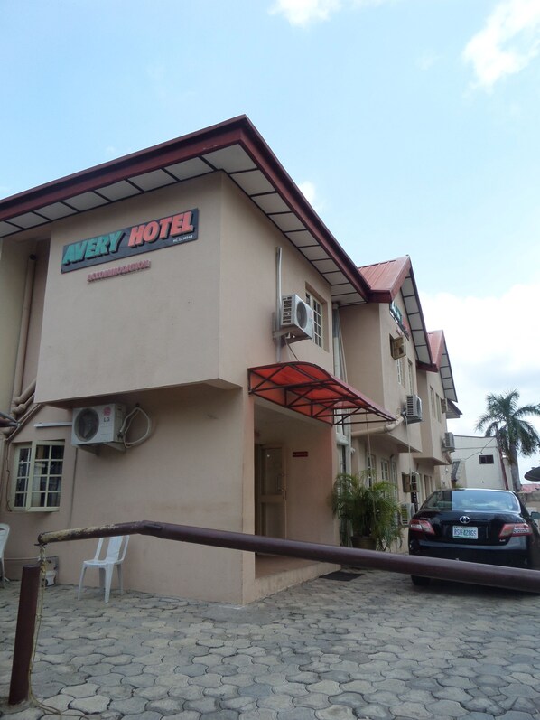 A hotel with a sign reading "Avery Hotel" and an air conditioning unit. - Avery Hotel (Abuja)