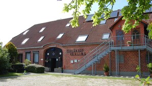 A building with a red-tiled roof, a staircase leading to an upper level, and a sign that reads "STUDENT HOUSING". - Vacation apartment Schlei - Ferienhof Röhling between Schlei and Baltic Sea (Kappeln)
