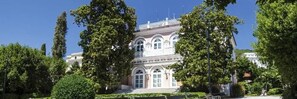 A historic building with a symmetrical facade, large windows, and a central entrance. - Hotel Continental (Opatija)