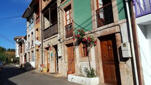 A row of traditional buildings with balconies, some with flower boxes.