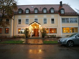 A hotel with a traditional European architectural style, featuring a symmetrical facade, multiple windows, and a central entrance with a canopy.