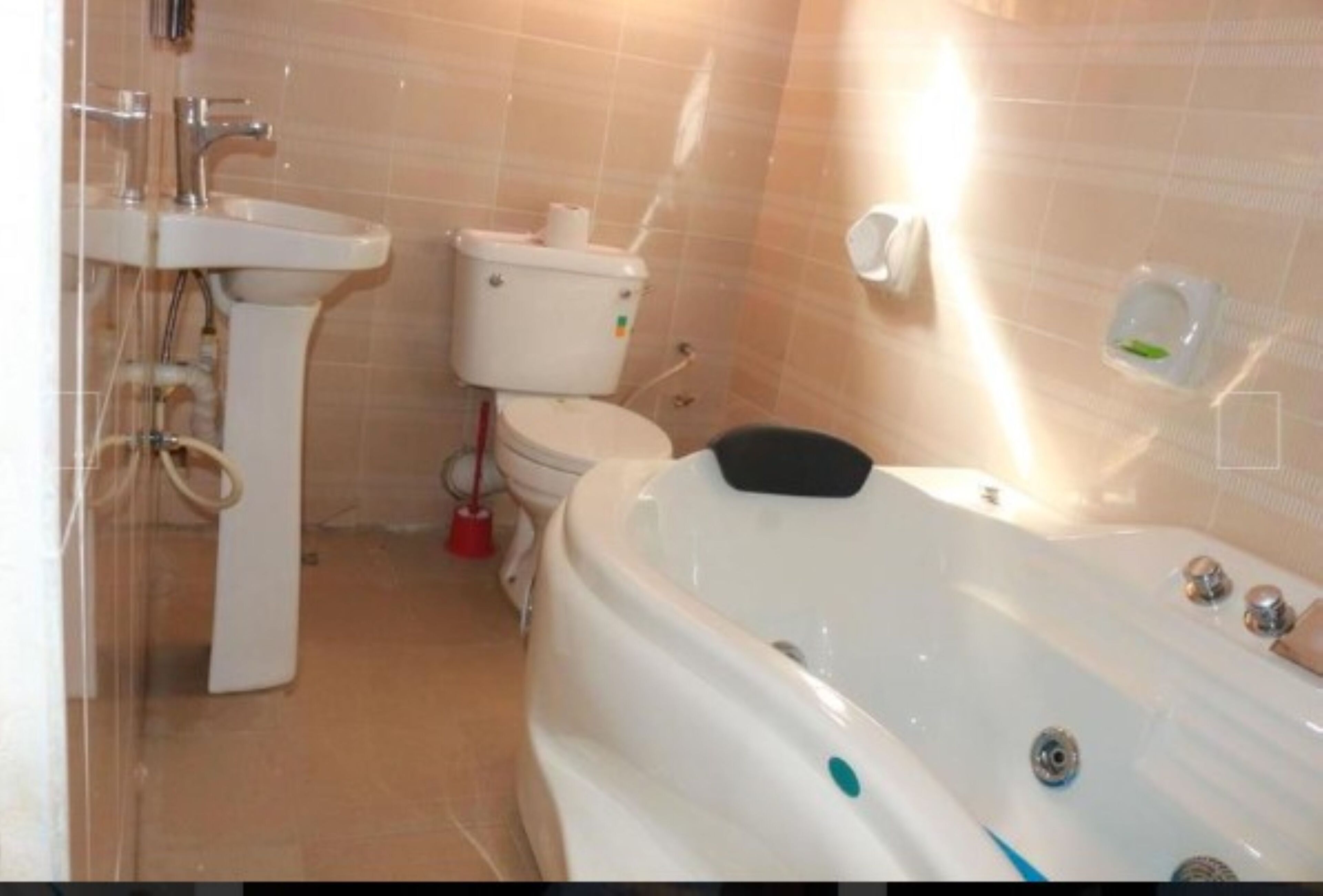 A bathroom with a sink, toilet, and bathtub.