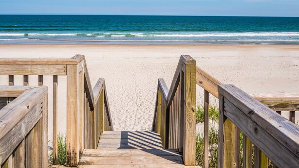 A wooden boardwalk leading to a beach with a clear view of the ocean. - Queen's Grant 211-C | Oceanfront + Sound Views! (Topsail Beach)
