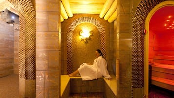 Experience ultimate relaxation in our serene spa area, featuring an alcove with a tiled floor and walls, perfect for unwinding.